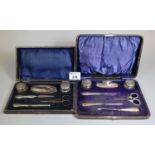 Two similar cased travelling silver mounted manicure sets with steel blades. (2) (B.P. 21% + VAT)