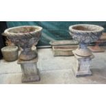 Pair of composition classically designed urn-shaped planters with moulded foliate decoration