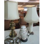 Three lamps to include: one with brass base and cream shade, one white ceramic lamp base with