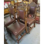 A set of four late Victorian oak dining chairs having carved stylised dragon decoration on fluted