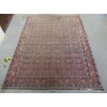Middle Eastern design carpet on salmon ground with multicoloured floral and foliate borders and