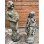 Two modern composition garden ornaments in the form of classical women dressed in robes, on circular