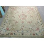20th Century green and beige carpet of large proportions decorated with oriental style flowers and