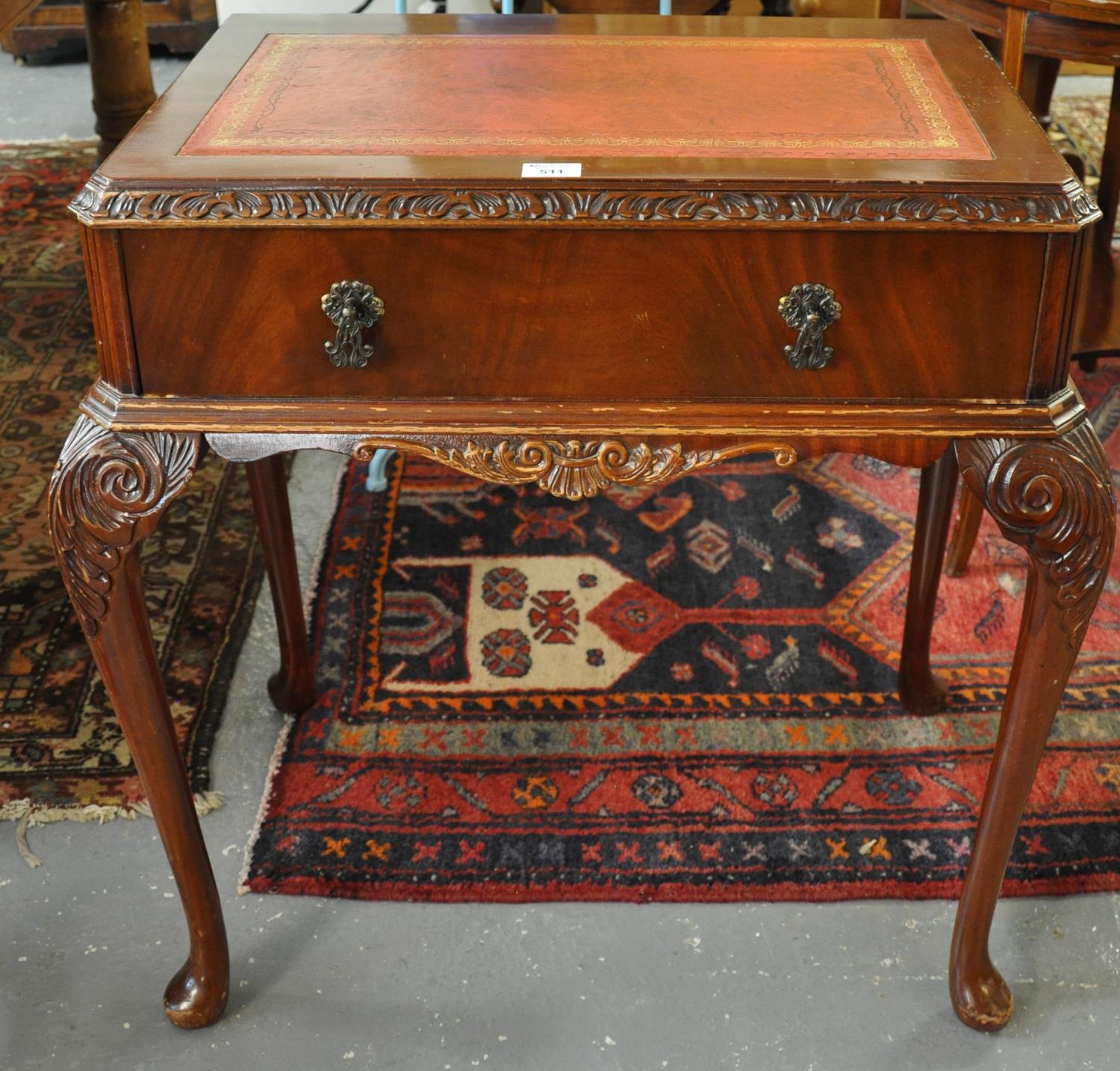 Reproduction mahogany writing desk with leather insert top above single pull-out drawer on