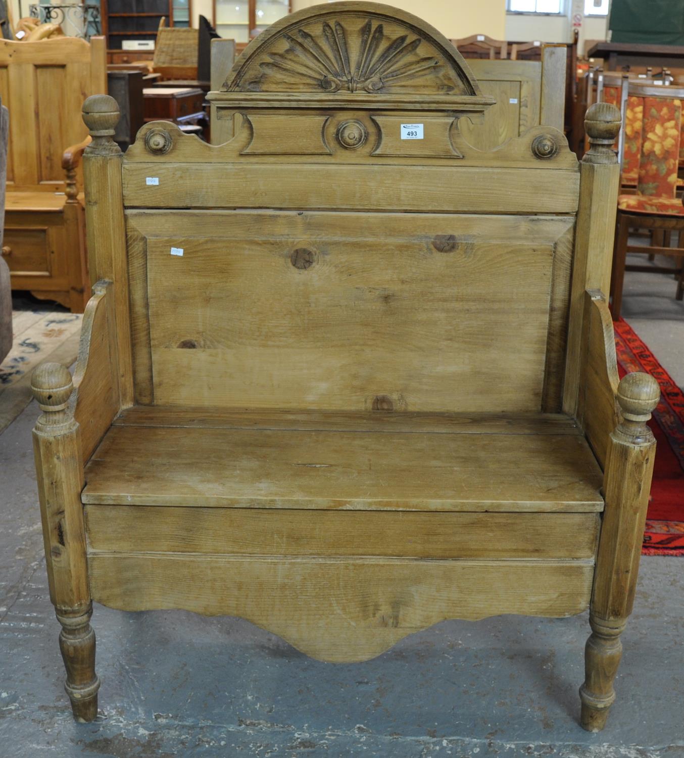 Pine high back hall bench/settle with shaped arms flanked by two chamfered pilasters and a shaped