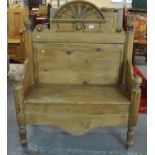 Pine high back hall bench/settle with shaped arms flanked by two chamfered pilasters and a shaped