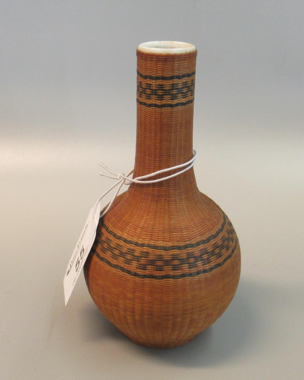 20th Century Chinese porcelain small bottle vase in a woven bamboo decorative cover. (B.P. 21% +