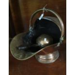 Vintage copper helmet shaped coal scuttle with swing handle, together with matching shovel. (B.P.