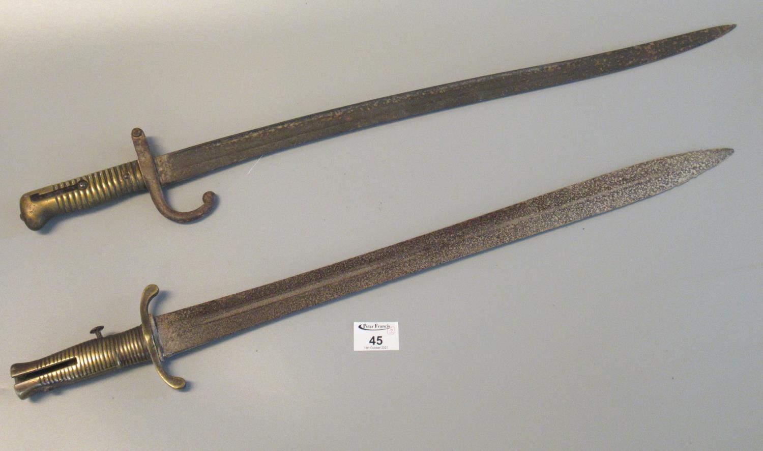 19th Century sword bayonet with brass hilt and cross guard, together with another probably French
