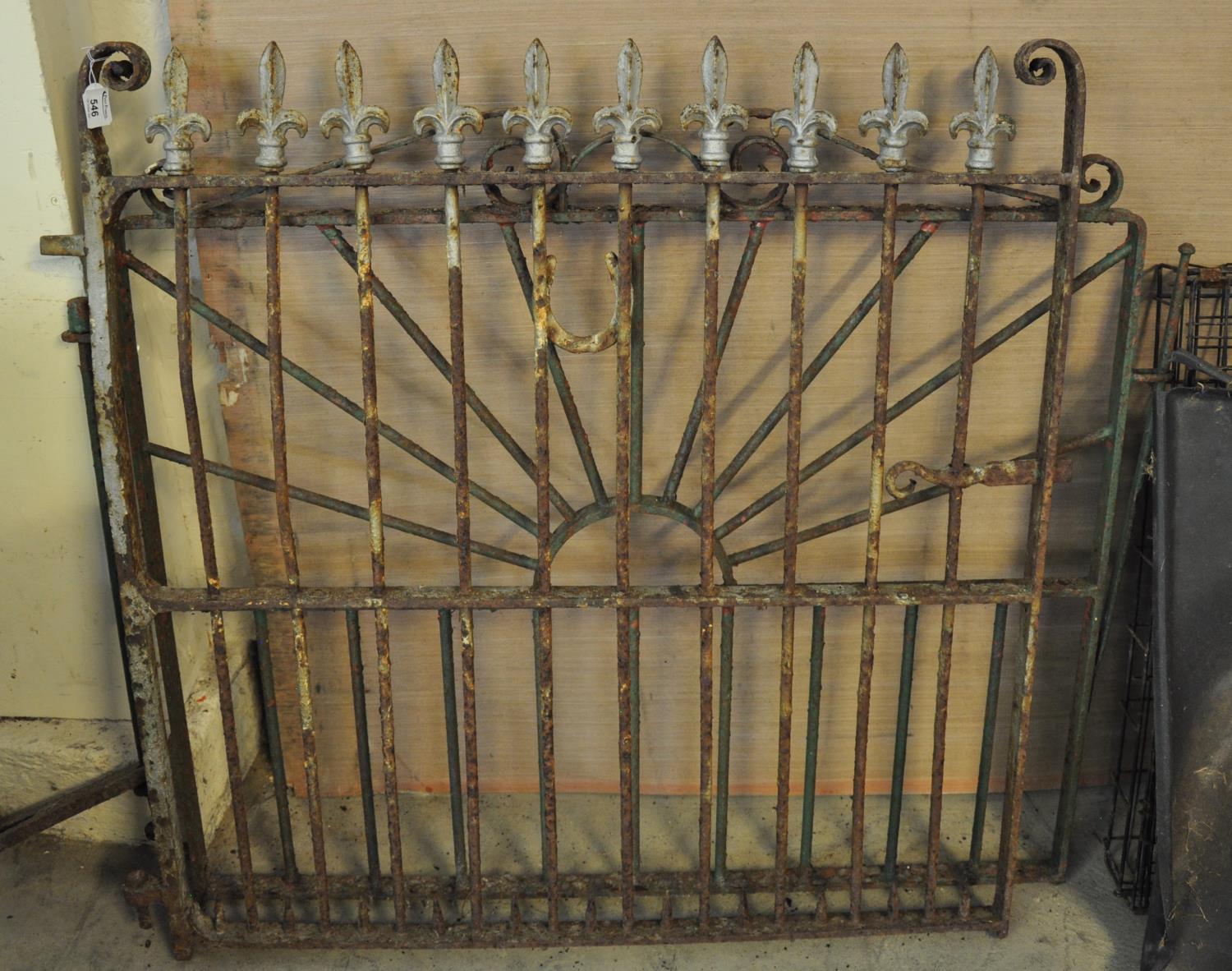 Two wrought iron garden gates, one with fleur-de-lis design. (2) (B.P. 21% + VAT)