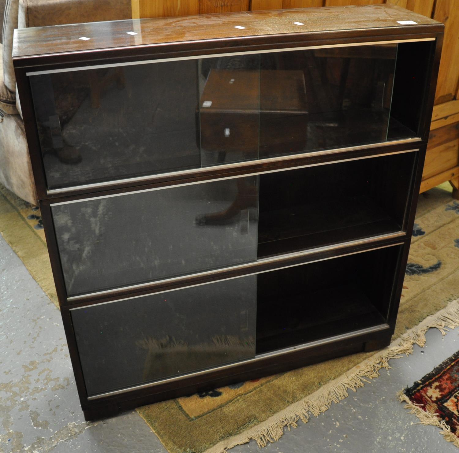 Mid century mahogany three-section sectional bookcase with glass sliding doors. (B.P. 21 + VAT)