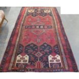 Middle Eastern design red and blue ground carpet, the central panels with floral motifs, flanked