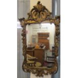 19th century style gilt mirror, the frame decorated with flowers and foliage. (B.P. 21% + VAT)