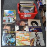 Box containing 53 vinyl records including Bob Dylan, Al Stuart, Bob Marley and the Wailers, Eric