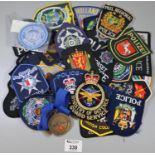 Tin box comprising assorted police badges to include Police Heddlu, Twinsburg, Dyfed County Fire