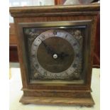 An Elliott of London oak cased Georgian style mantel clock with back winding movement and Roman