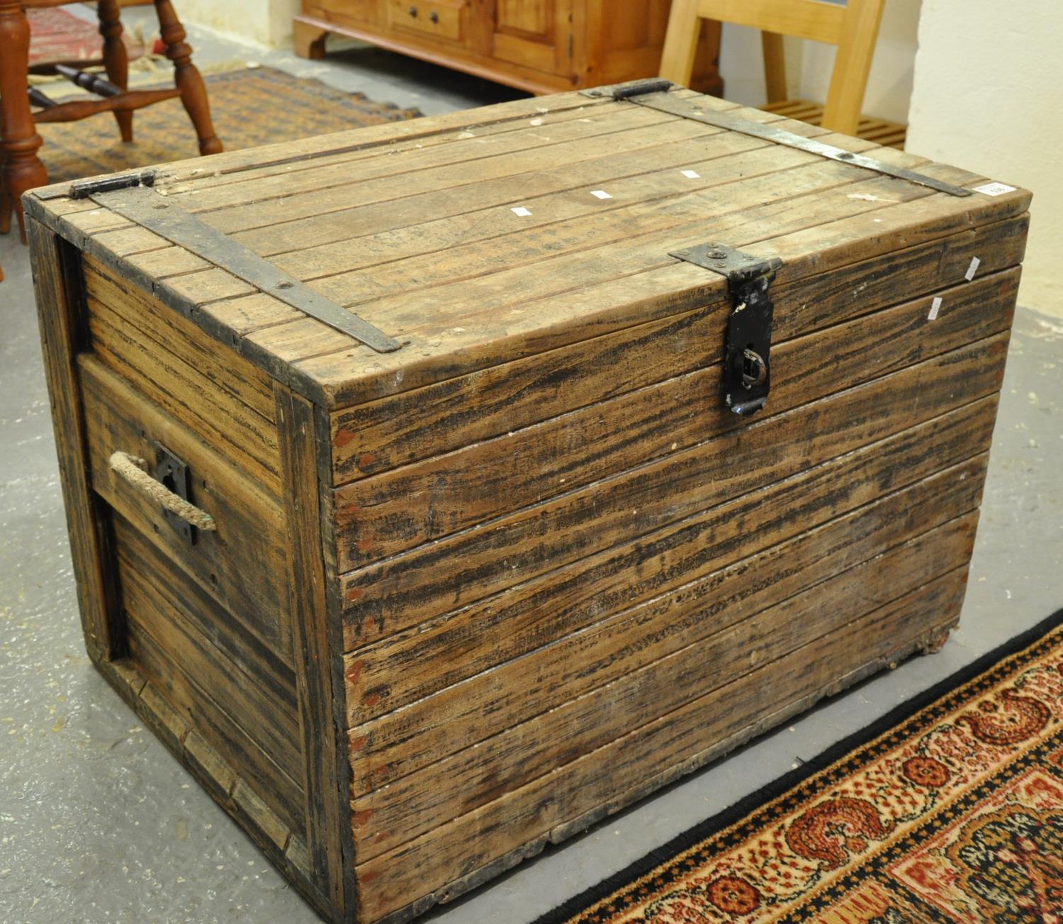 Vintage pine trunk of rectangular form with metal hinges and lock and rope and metal recessed