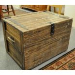 Vintage pine trunk of rectangular form with metal hinges and lock and rope and metal recessed