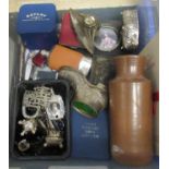 Plastic tub of assorted items to include art nouveau style ink well, coin sets, various lighters,