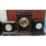 Three early 20th Century mantel clocks, various including; black slate and ebonised wooden cases. (