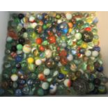Cardboard box of assorted glass coloured marbles, varying size. (B.P. 21% + VAT)