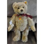 Steiff light golden brown teddy bear with burgundy bow. (B.P. 21% + VAT)