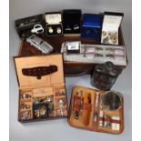Small vintage leather suitcase with various contents including silver plated and leather hipflask,