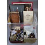 Plastic box containing military interest to include information of the Somme, military cap badges,