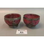 A pair of oriental red stained hardstone white metal bound small bowls, 20th Century. (2) (B.P.