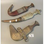 Three Arab type Jambiya daggers with white metal mounts. (3) (B.P. 21% + VAT) These items cannot