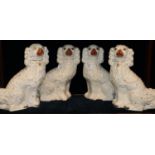 Two pairs of Staffordshire fireside seated spaniels with painted features. (4) (B.P. 21% + VAT)