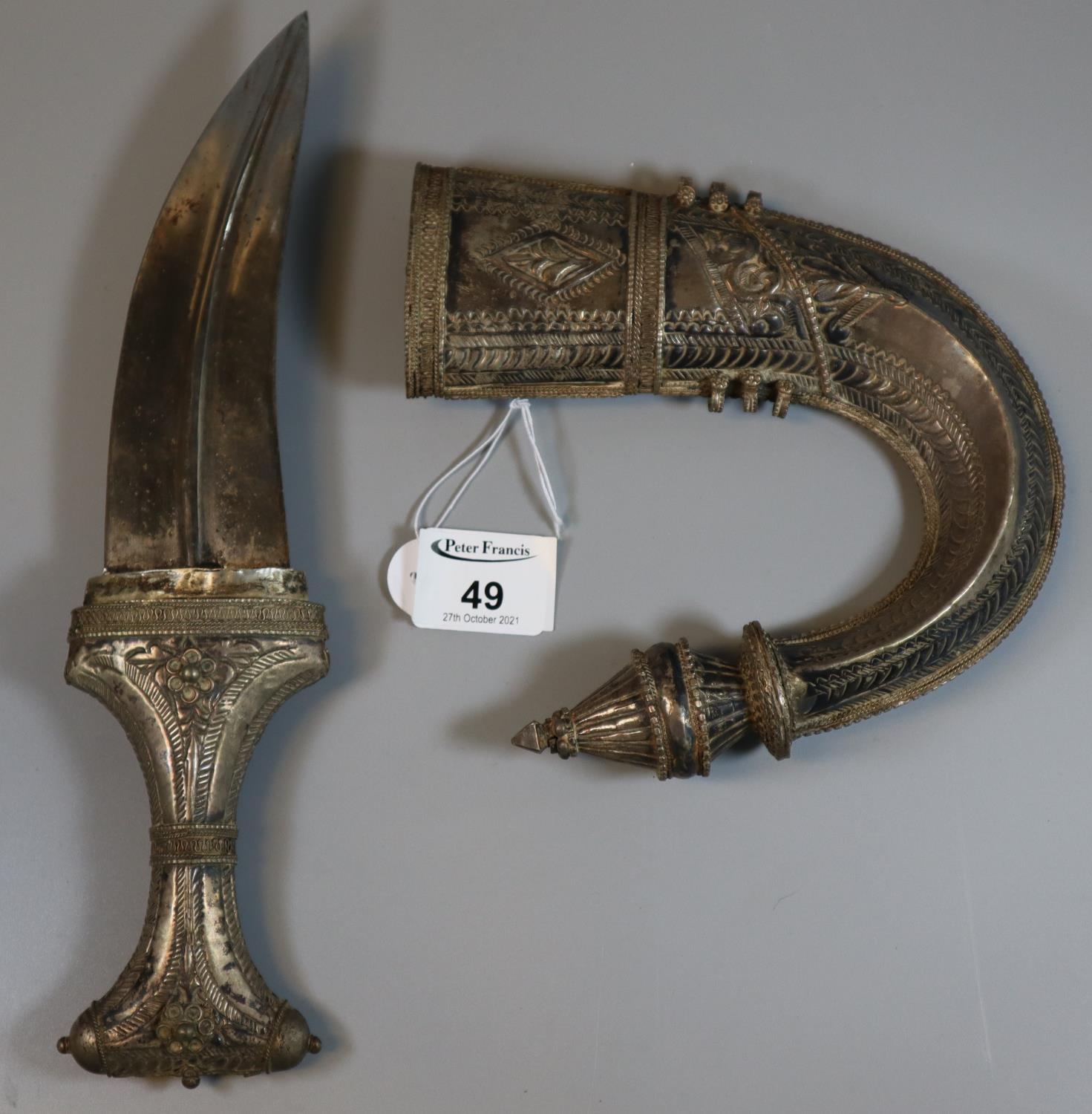 Arab Jambiya type dagger , the sheath and handle with repousse white metal decoration. (B.P. 21% +