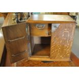 Early 20th Century oak two door blind panelled smokers cabinet, the interior revealing fitted