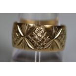 9ct gold wide engraved wedding ring. Ring size R. Approx weight 4.4 grams. (B.P. 21% + VAT)