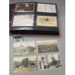 An album of nearly 300 postcards and photos to include; military, local interest Carmarthen, Cardiff