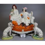 Pair of small Staffordshire pottery fireside seated Dalmatians on naturalistic bases, together