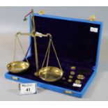 A cased set of brass apothecary scales with weights. (B.P. 21% + VAT)