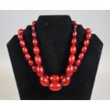 Two graduated strings of 1930's red bakelite beads (B.P. 21% + VAT)