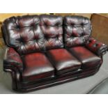 Modern leather Chesterfield style oxblood three seater sofa. (B.P. 21% + VAT)