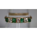 18ct gold emerald and diamond six stone ring. Ring size O. Approx weight 2.6 grams. (B.P. 21% + VAT)