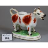 19th Century Staffordshire cow creamer on naturalistic oval base. (B.P. 21% + VAT)