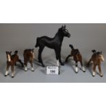 Four Beswick foals, together with a Royal Doulton black foal. (5) (B.P. 21% + VAT)