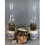 Royal Doulton china 'Paddy' large character jug, together with a pair of double burner oil lamps