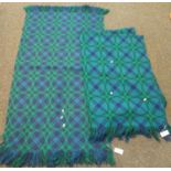A blue and green geometric design tapestry woollen blanket, with a similar rug and a vintage black