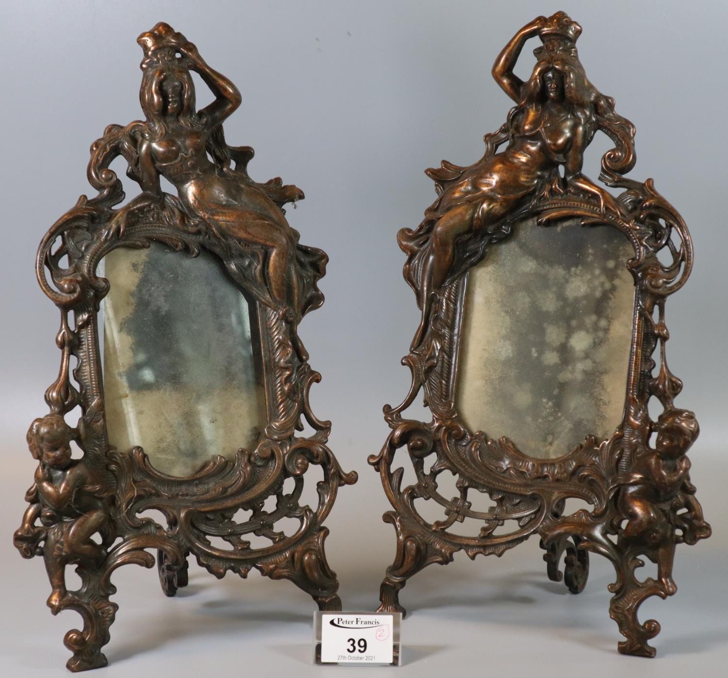 Pair of oxidised metal mirror or photograph frames in Rococo style with figure mounts. 32cm high