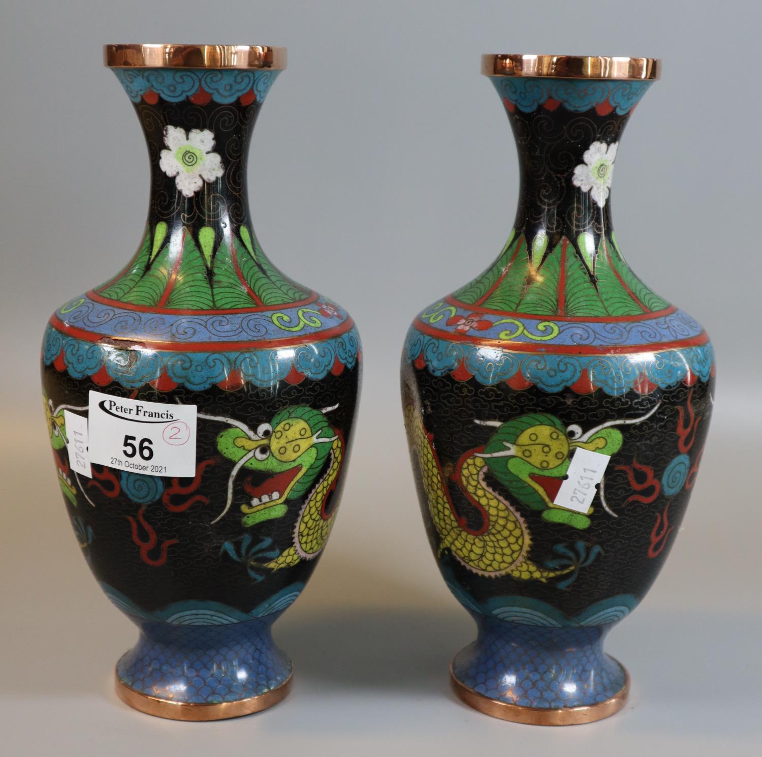 Pair of Chinese black ground cloisonne baluster shaped vases depicting dragons chasing flaming