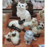 Collection of china cats, together with a pair of carved wooden cat bookends. China cats include: