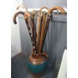 Large pottery baluster shaped jug containing a good selection of various walking sticks including