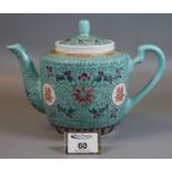 Modern Chinese porcelain teapot decorated with stylised lotus and shou roundles on a turquoise