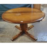 Elm Ercol centre table on quatreform base. (B.P. 21% + VAT)